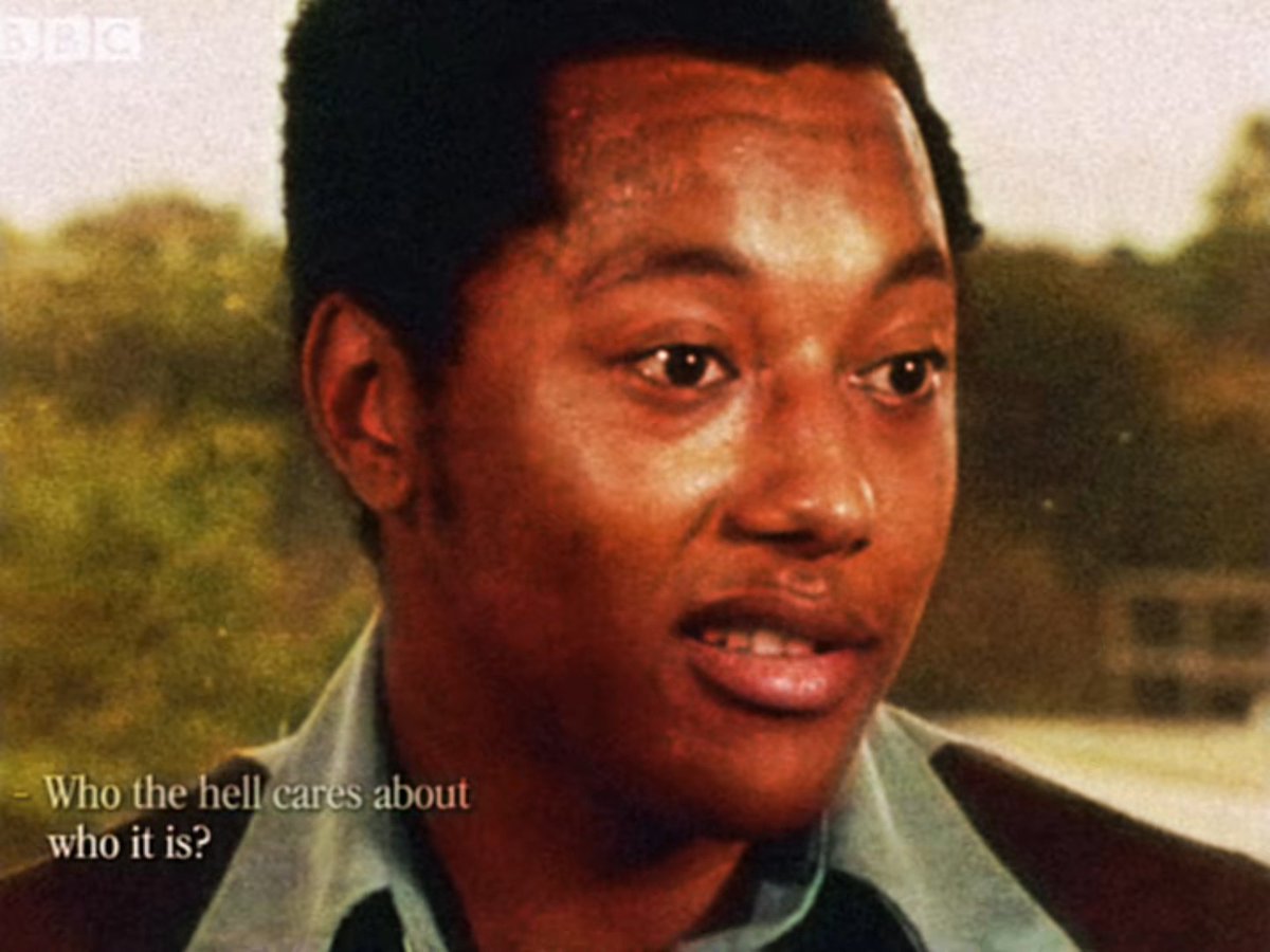 A still from a BBC documentary showing a young Black man speaking, with the subtitle 'Who the hell cares about who it is?'