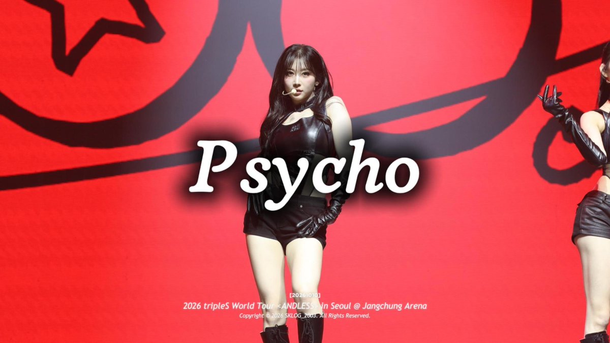 A performer in a black leather outfit performs on stage at the '2026 tripleS World Tour ~ANDLAND~ in Seoul @ Jangchung Arena' with 'Psycho' displayed on screen.