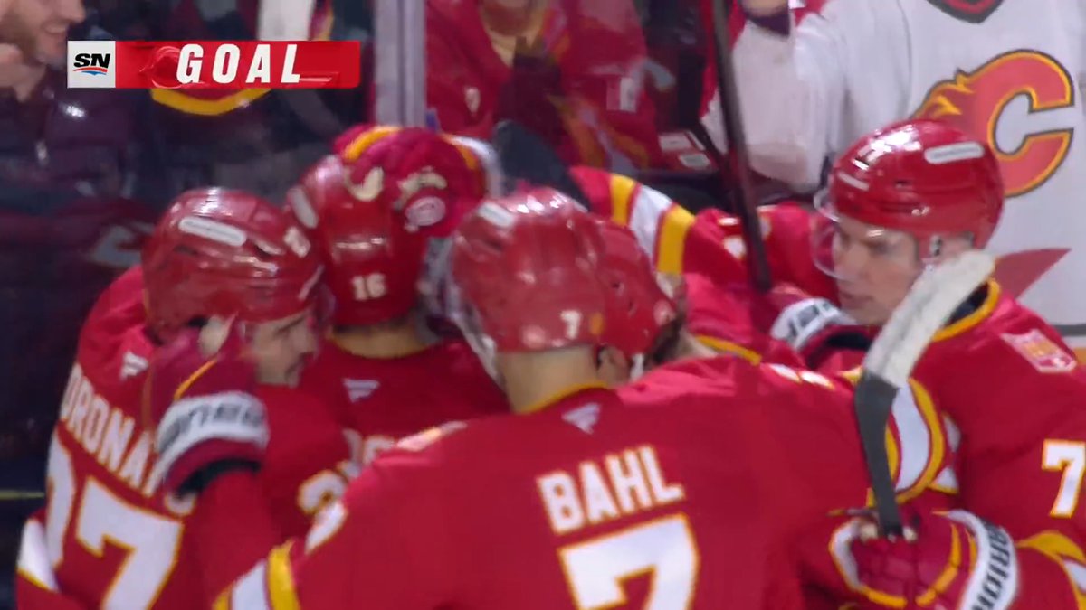 Calgary Flames players, including #77 (Korhonen) and #7 Bahl, celebrate a goal as shown by the "GOAL" banner and SN network logo in the corner, contrasting with the "Ewwwwwww" caption to suggest a displeased reaction to the score.