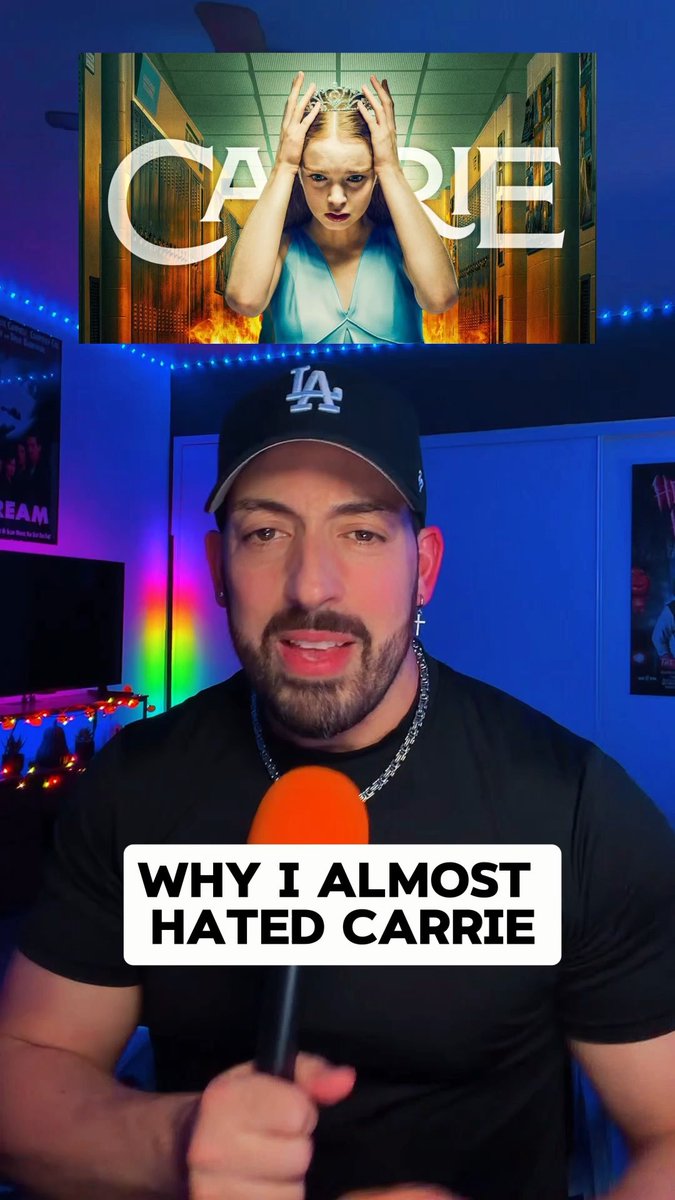 A man wearing a black LA Dodgers cap and shirt speaking into an orange microphone, with the 'CARRIE' movie poster behind him and a text overlay reading 'WHY I ALMOST HATED CARRIE'.