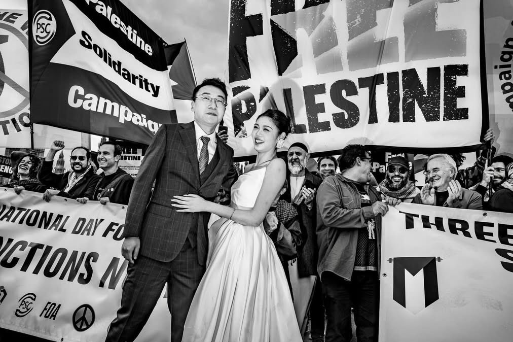 landpalestine's tweet photo. A newly married couple took time out from their wedding celebration and photo shoot to join the Palestine Solidarity March and show their support for the cause  in London https://t.co/CE880w2MQp