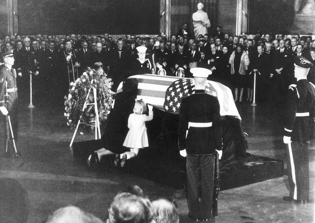 fasc1nate's tweet photo. On November 24, 1963, Jacqueline Kennedy spent a few private moments beside the casket of her husband, President John F. Kennedy. Before his body was taken from the White House to lie in state at the U.S. Capitol, Jackie reportedly placed several personal items inside his casket.

Among them were a pair of gold cuff links, a silver rosary, a scrimshaw engraved with the presidential seal, and a PT-109 tie clip. The tie clip represented Kennedy’s service during World War II, when the patrol boat he commanded was struck and sunk by a Japanese destroyer. Kennedy helped lead his surviving crewmen to safety.

Jackie also reportedly placed a handwritten letter inside the casket. It was a final, deeply personal message to the husband she had suddenly lost. Unlike the countless photographs, speeches, and documents surrounding Kennedy’s death, the letter was never intended for the public.

In the days following the assassination, Jackie remained remarkably composed in public. She famously continued wearing the bloodstained pink suit she had worn beside Kennedy in Dallas, saying she wanted people to see what had happened.

The casket was eventually sealed, carrying those personal objects and Jackie’s private farewell with it. On November 25, Kennedy was taken by horse-drawn caisson through Washington before being buried at Arlington National Cemetery. 

The most haunting photos ever taken: https://t.co/POrqRRccxc