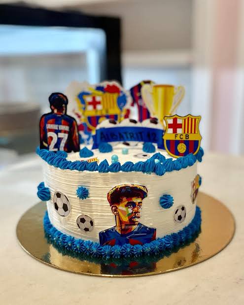 nautfcb's tweet photo. People have asked me what I will do when Lamine Yamal wins The Ballon D’or.

I have already planned so much.

Firstly, I will be going to my local baker, and asking her to design a cake, as attached on the image. I will be cutting and eating it after the ceremony. I will be eating it with my nephew, my mother, and I will even try to see if my ex girlfriend will allow my son to attend, as this occasion would be one of the most important days of my life.

My father will not be invited, as he will just insult me.

But before that, I will be doing his celebration when the winner his announced.

Finally, I will be cooking for the day. Lamine Yamal’s favourite food is hot dogs, so I will be making hot dogs for the entire family. Homemade sausages. I have ordered a sausage press just for this. And as per my restaurant idea, I will make it Lamine Yamal themed. Lamine Yamal dogs.

But I feel I could do more, for such a special event. I do not know.