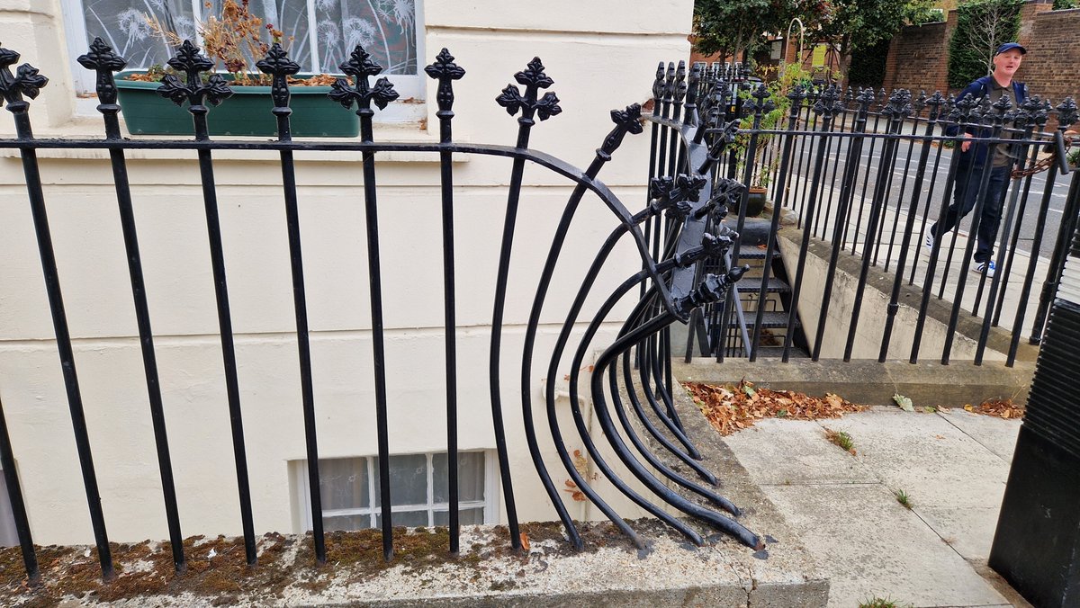 VinnieSull1van's tweet photo. Whilst in Clerkenwell, we noticed this strange railing on the corner of Packenham street and Wren street. Though we concluded that a car had run into it, it looked too perfect to have been an accident. It looks more like a modern art instillation than the result of a crash. https://t.co/LescRJSkTo