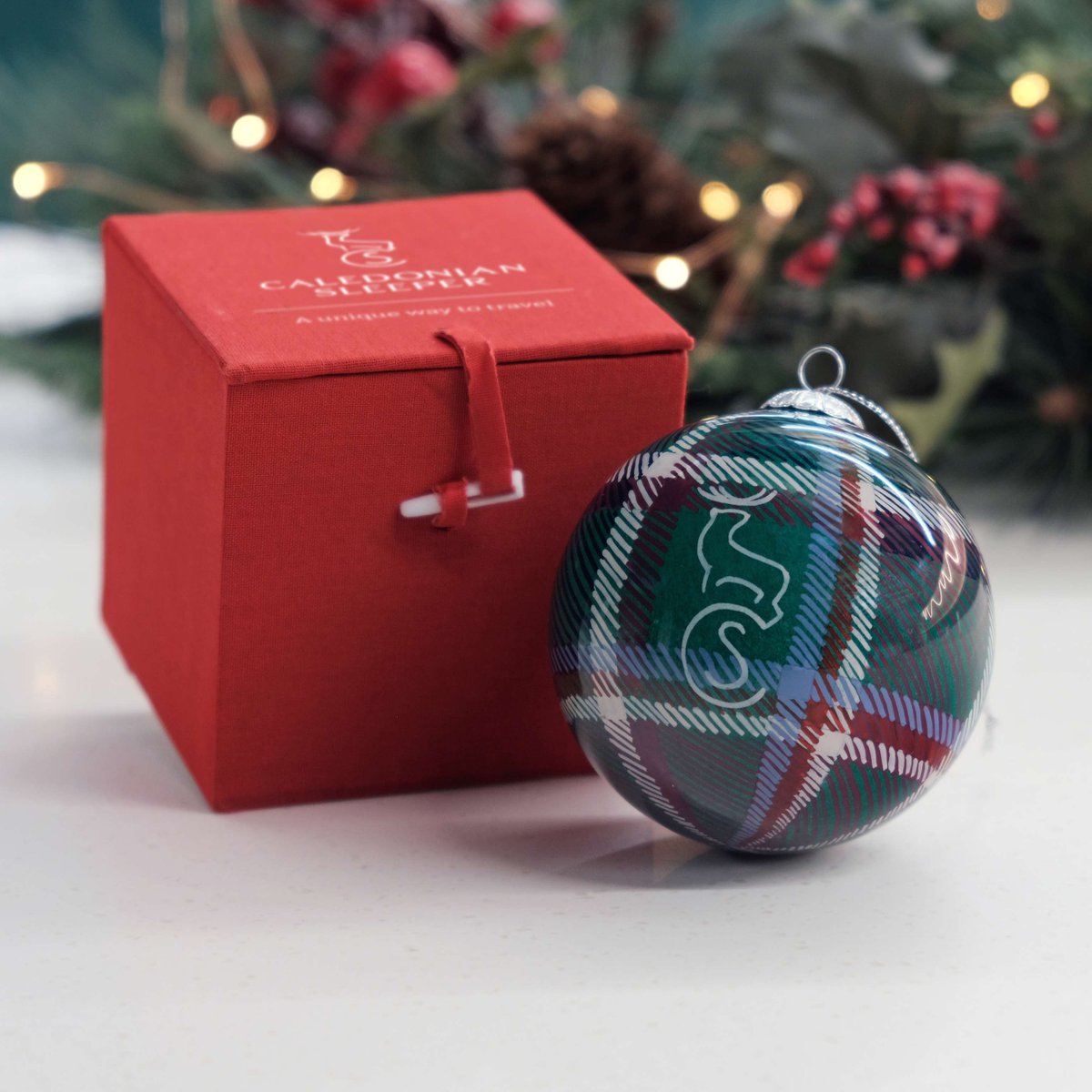 CalSleeper's tweet photo. Introducing our new Christmas range, bringing a little Caledonian Sleeper magic to the festive season! 🎄

From our brand-new Christmas 2026 jumper, complete with a matching bobble hat, to our first-ever 2027 Sleeper calendar, there’s something for every railway enthusiast. 🚂

Our jumper is packed with railway-inspired details to discover, and sales will help support our charity partner, @RailwayChildren

Plus, our much-loved hand-painted tartan baubles are back, ready to add a touch of Sleeper style to your Christmas tree. ✨

Discover the range and find your new festive favourite! 🎁
https://t.co/01rEICAfZo