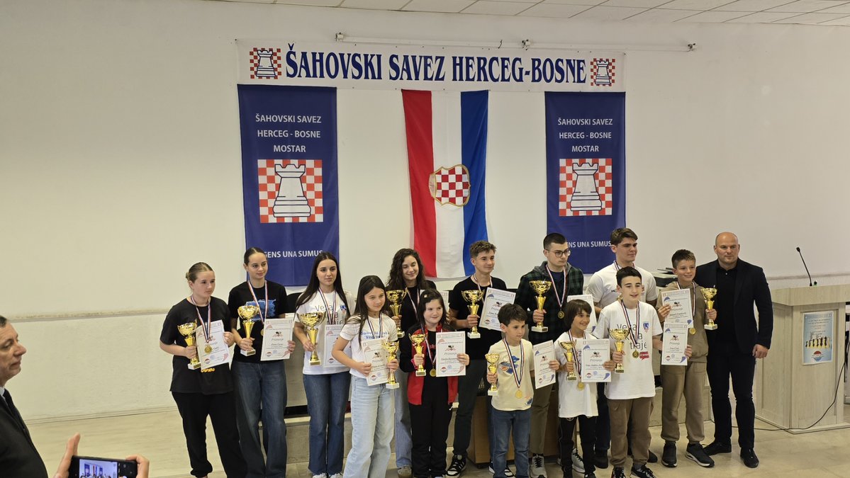 FIDE_chess's tweet photo. ✨ Chess schools worldwide can become part of any child's educational journey. In Vitez, a small town in Bosnia and Herzegovina 🇧🇦, the chess club tries to bring children together to teach them about life through chess.

♟️ "The Vitez 2013 Chess School currently brings together around 30 children and young people. Our aim is to make chess accessible to every interested child, regardless of their family's financial circumstances. Through regular training, tournaments and club activities, children learn not only chess, but also concentration, patience, responsibility, logical thinking, respect for others, and how to deal with both success and disappointment.

We regularly travel with our young players to tournaments in different parts of Bosnia and Herzegovina, giving them opportunities to compete, gain experience, make new friends and discover the wider chess community. In the future, we would love to give them the opportunity to travel and compete beyond our country as well, allowing them to meet young chess players from other countries and cultures.

We are also particularly happy to see a growing number of girls joining our chess school. More and more girls are showing interest in learning and competing, and we want chess to be equally welcoming and accessible to girls and boys. Seeing children of different ages and backgrounds — girls and boys alike — sitting together at the chessboard is one of the most rewarding parts of our work.

🔸 The impact of the club therefore goes far beyond the chessboard. We want to provide children with a safe and positive environment where they can spend their free time learning, developing friendships and feeling that they belong to a community. Parents, coaches, volunteers and local supporters become part of this community as well, making chess a way of bringing people and generations together.

🔹 As part of our efforts to bring chess closer to the wider community, we recently organized a special event called “Chess Goes to Town” (“ŠAH izlazi u grad”). The highlight was a simultaneous exhibition by Croatian Grandmaster Alojzije Janković, a chess author, television presenter and passionate promoter of the game. Children, club members and members of the local community had the opportunity to play, socialize, analyze games and celebrate chess together in a very special atmosphere.

Events like this allow us to take chess beyond our club's walls, making it visible and accessible to the wider community. Most importantly, they give our young players an opportunity to meet accomplished chess players, learn from them and experience chess as something much bigger than their regular training sessions."

👏 Kudos to Miroslav Ivančić and the team behind the Vitez 2013 Chess School, which combines chess, community, and culture as part of the educational journey of the child. 

Know an educational chess project making a difference?
✉️ Share it with us at socialmedia@fide.com  

#EducationalChess2026 #EveryLessonCounts