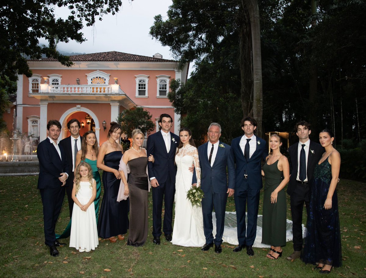 RobertKennedyJr's tweet photo. Conor and Giulia's wedding in Rio. Group photo from left : Bobby, Vanni, Bobcat, Kick, Amaryllis, Cheryl, Conor, Giulia, Me, Finn, Cat, Aidan, Kyra https://t.co/kaFjvXJdI5