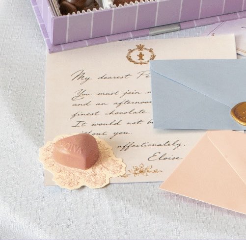 chaoticguitar's tweet photo. So Bridgerton has a new collab with Godiva chocolate and I just zoomed into the promotional image… it’s a LETTER from Eloise to pen 👀 https://t.co/R2ke3yoeVk