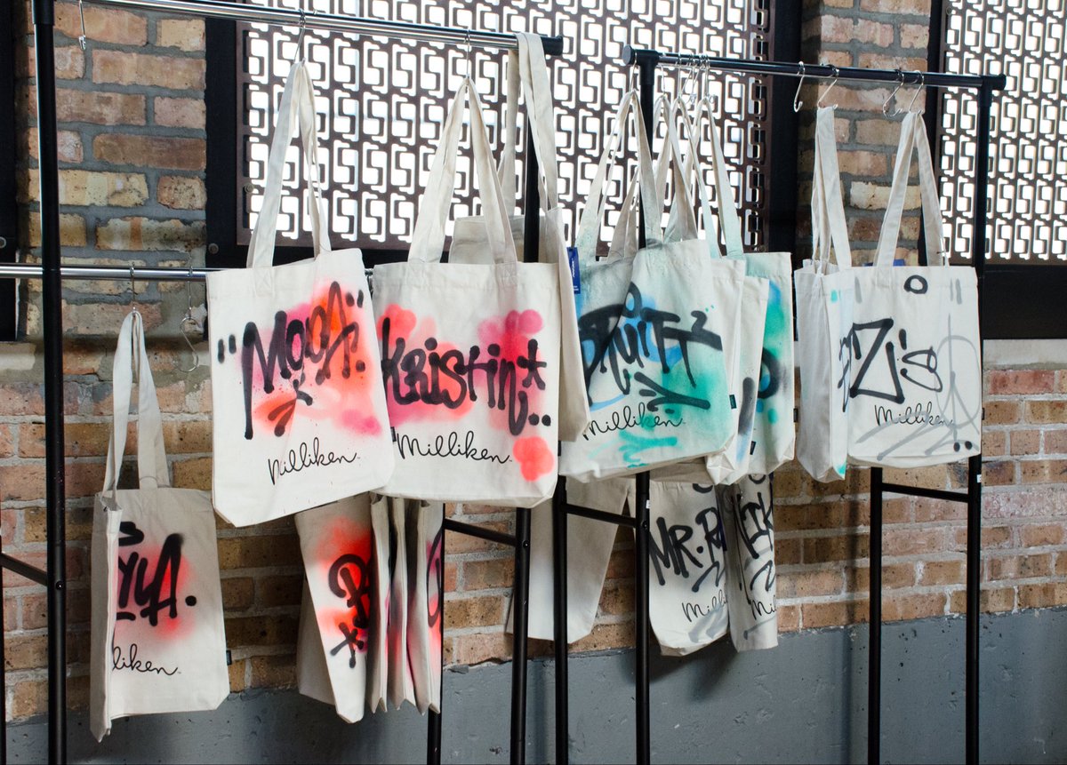 Graffiti_USA's tweet photo. Custom graffiti swag is how you stand out at a show. At NeoCon in Chicago, we tagged guests’ tote bags in a black graff style, right at the booth. Take-home gifts that are functional AND fun. #GraffitiArt #CustomSwag #NeoCon #LiveArt #StreetArt #ToteBags https://t.co/kghZqfGp0u