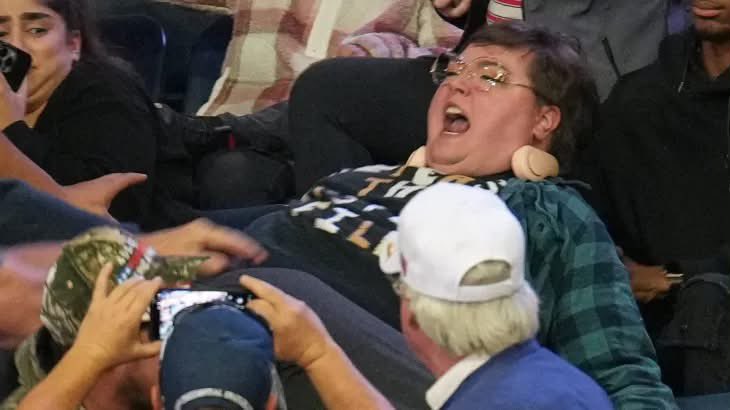 landpalestine's tweet photo. This woman wearing a  Release the Epstein Files" shirt stood up at Trump rally 

At least four men attacked her. She was grabbed, punched and shoved to the ground

The police escorted her out.
The men walked free.
Trump just smiled and called her "fat."

When the most powerful man in the world mocks a woman while she's being attacked, every abuser watching hears permission
