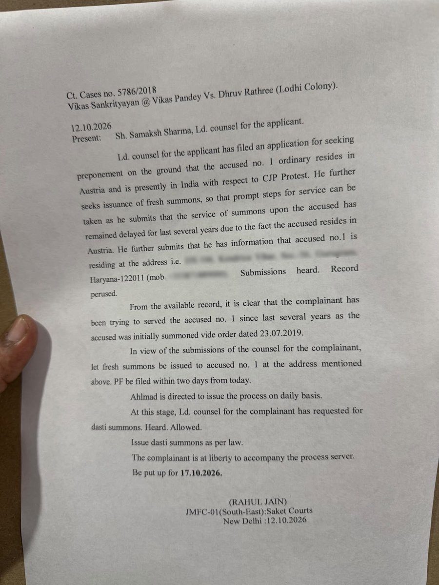 ians_india's tweet photo. A Saket court has ordered fresh summons to YouTuber Dhruv Rathee at a Gurugram address in a case filed by Vikas Sankrityayan, also known as Vikas Pandey. The court allowed dasti service, permitting the complainant to accompany the process server. The next hearing is scheduled for October 17