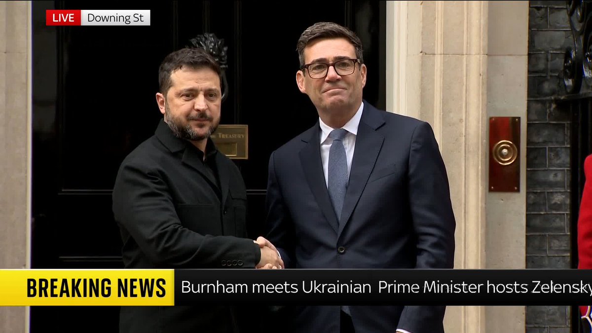 A 'LIVE' news broadcast from 'Downing St' shows Volodymyr Zelenskyy shaking hands with another man at a building entrance, with a 'BREAKING NEWS' ticker reading 'Burnham meets Ukrainian Prime Minister hosts Zelensky.'