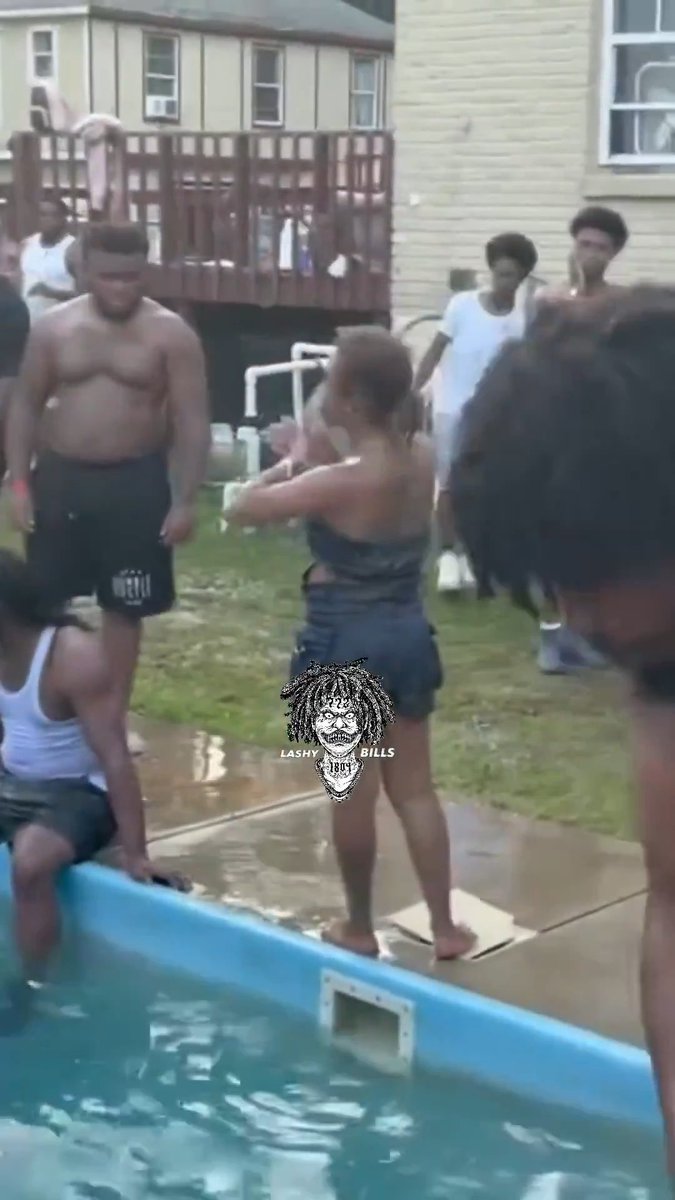 A drunk woman in a black swimsuit aggressively swings her fists at people around a dirty backyard pool, while shirtless men and onlookers watch or step back to avoid her at what appears to be a chaotic summer pool party. The watermark "LASHY BILLS" appears over the scene, matching the post's description of the intoxicated woman trying to fight everyone at the gathering.