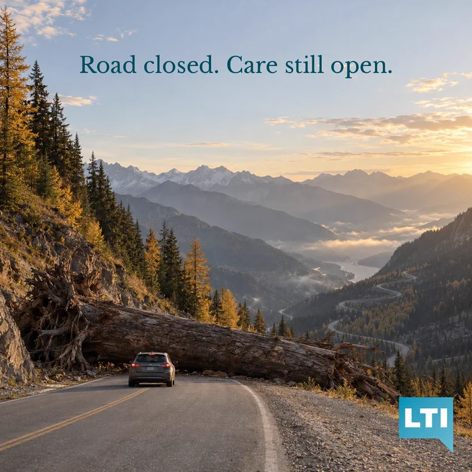 A giant fallen tree blocks a winding mountain road in autumn while a small car waits in front of it, with switchbacks and a misty valley below.