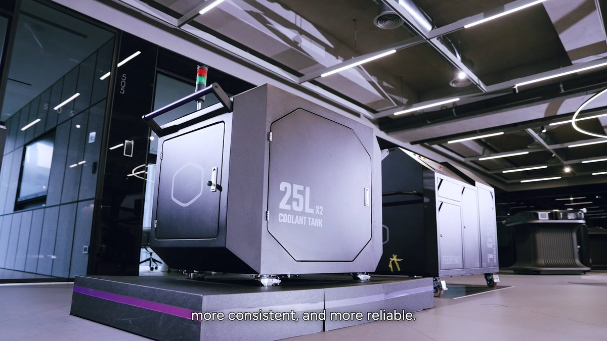 A Cooler Master Loop Charge Kit is displayed in a modern industrial setting, prominently featuring a gray unit labeled "25L x2 COOLANT TANK." The setup appears designed for commissioning and servicing liquid-cooling systems, aligning with the post's description of a versatile system for filling, draining, purging, and pressure-testing cooling loops with built-in filtration and monitoring.