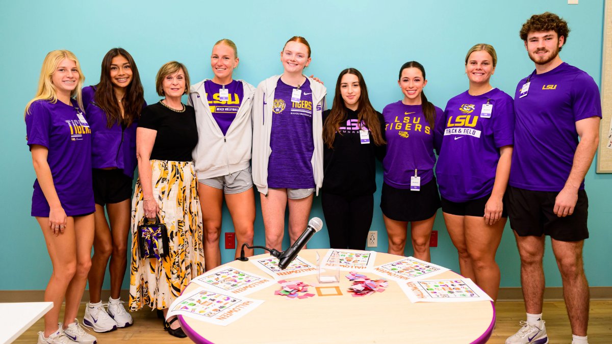 LSUpresident's tweet photo. Miss Angela joined @LSUGym @LSUTrackField and @LSUBeachVB to bring a little purple and gold to the children at @FMOLHealth Children’s Hospital. We are grateful to our student-athletes for sharing their time and hearts with these young Tigers and their families. @Athletesforhope @ololchildrens #LSU