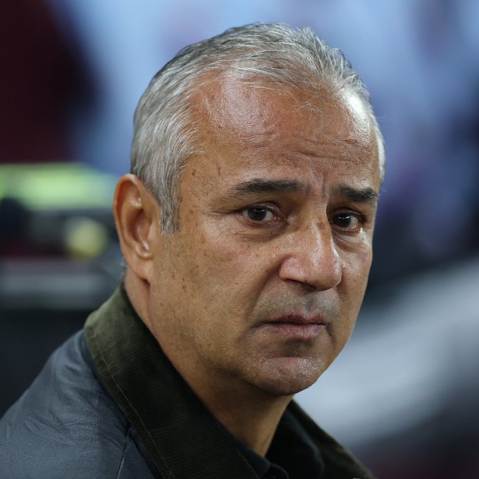 A close-up portrait shows a gray-haired man with a serious, focused expression looking slightly off-camera, wearing a dark collared jacket against a blurred background. His stern, contemplative demeanor appears to match the post's reference to giving tactical advice rather than showing emotion.