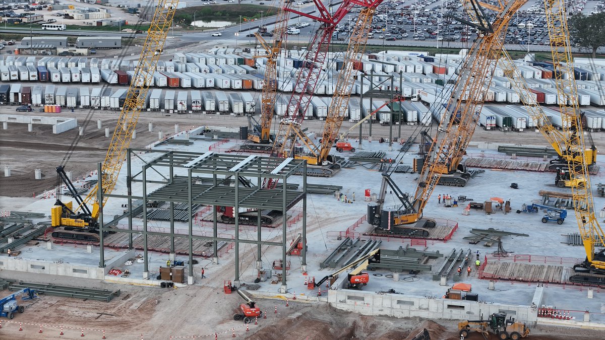 JoeTegtmeyer's tweet photo. On the E side of Giga Texas, the joint @SpaceX & @Tesla Advanced Tech Chip Fab foundation continues to receive huge concrete pours working to the N grade beam, while more footing & Footing support structures are completed on the S end. 

Steel erection on both the E & W sides of the center area is accelerating along with large steel truss structure assembly nearby, possibly to span the width of the foundation. This design ^ assembly is vastly different than any other structure on the site.

Large numbers of steel beams, many with welded on massive joining tabs have been delivered to the site while the nearby new concrete mobile batch plant is in operation to support construction of this $3B Research & Development facility.