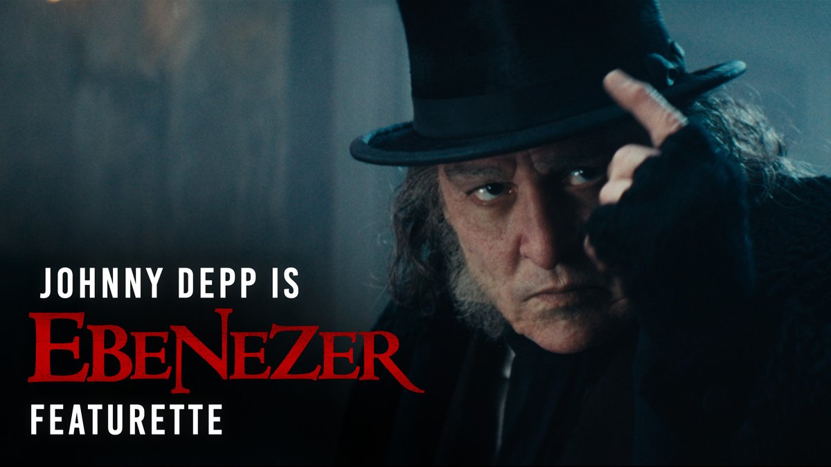 A promotional image for a featurette showing Johnny Depp in character as Ebenezer, wearing a black top hat and tipping it with his hand.