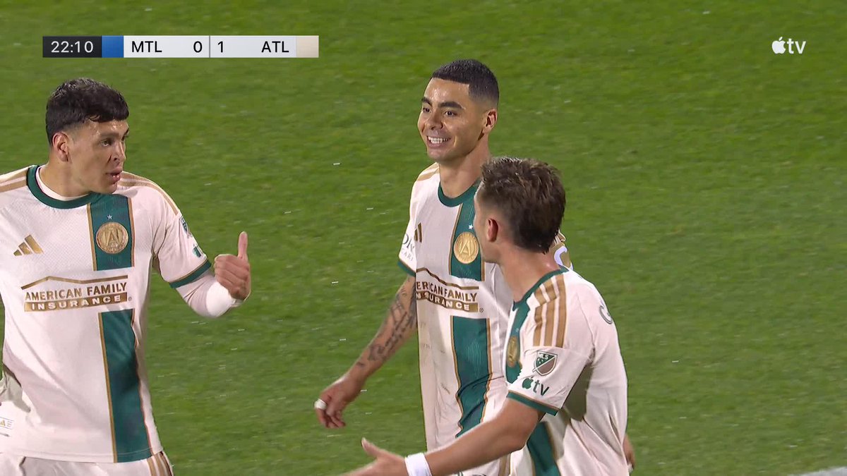 Atlanta United players, including goalscorer Miguel Almirón, celebrate his opening goal in a 0-1 lead over Montreal (MTL) at the 22:10 mark during an MLS match broadcast on Apple TV.