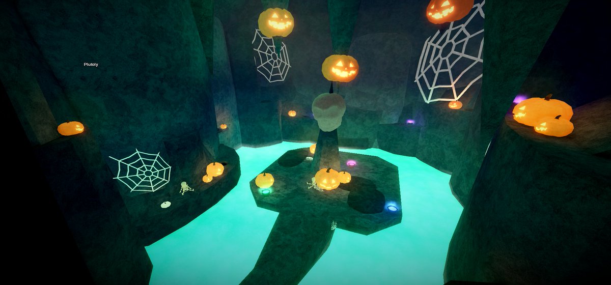 Fisch Halloween web-themed cavern scene Fisch Halloween cavern with glowing turquoise water, web decorations and carved pumpkins