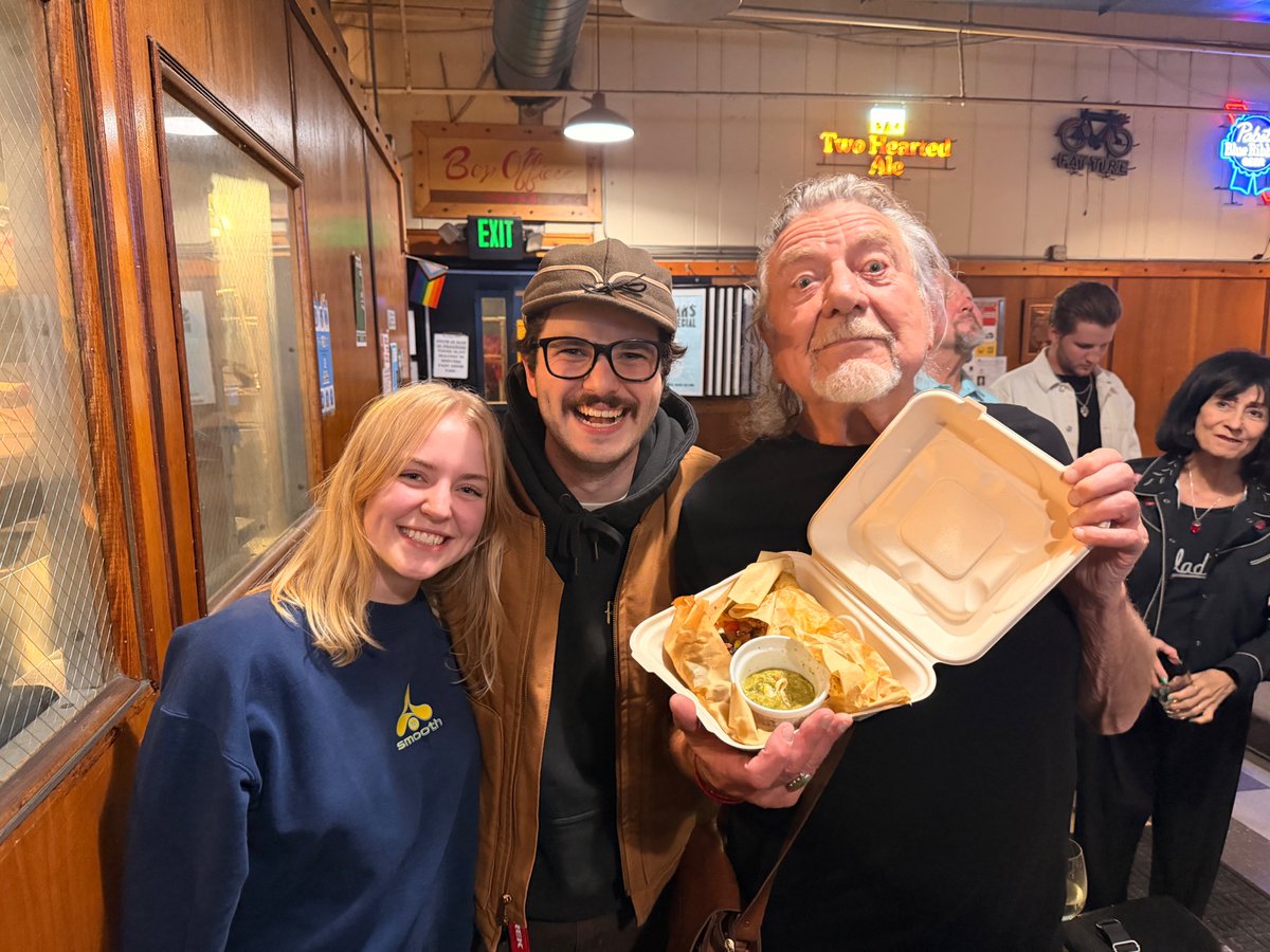 onlynateatkins's tweet photo. So I was home last night making dinner. Just as I was pulling the delectable frozen pizza from the oven my daughter called. She said she and her boyfriend were at Bryant Lake Bowl (a local bowling alley here in Minneapolis). They were 90% certain that Robert Plant was there bowling.

At first I scoffed. But she insisted and as we talked her boyfriend chimed in that he was positive that indeed it was Mr Robert Plant.

My heart raced. Led Zeppelin was the first band I obsessed over. The first vinyl I bought was Led Zeppelin III. A couple years later it was the same album I chose as my first CD purchase in 1989. They were foundational in my life and inspired my love of great music.

So I abandoned my dinner and took off in my truck to get there and possibly *fingers crossed* snag a picture with Mr Plant.

Along the way my daughter called, warning me to hurry as it looked like Mr Plant and his entourage were getting ready to leave.

I floored it.

I scored a parking spot right on Lake Street in front of Bryant Lake Bowl. Yes!

I calmly raced into the bowling alley and found that my daughter and her boyfriend with 2 lanes down from Mr Plant. They warned me that Plant's manager was preventing anyone from approaching Mr Plant.

But I knew I had to try. This was Robert friggin Plant, after all. How could I find myself so close to someone so foundational to my life and not try to at least express my gratitude for him and the music he created?

So I calmly approached Mr Plant. His manager obstructed me, shaking his head, "No, mate". I pleaded, "I just need to tell him how much his music has meant to me." "No, mate" his manager said again while shaking his head. I could tell I wasn't going to get anywhere and ultimately I chose to respect his boundaries and move on. I bowled a few rounds with my daughter (with Mr Plant a couple lanes over - and bowling better than me, I might add!), downed my beer and headed home.

I woke up this morning to this picture. It turns out my daughter's boyfriend (who plays in a bluegrass band here in the Twin Cities) struck up a conversation with Mr Plant's bandmates. They spoke for over an hour. Just as Mr Plant and his entourage were getting up to leave my daughter's boyfriend tried to ask for a picture. The manager re-buffed him. But, Mr Plant shrugged him off and motioned them over for a photo.

So this is them, with Mr Plant posing with their leftover nachos.

I wish I was there but it warms my heart that my daughter got to meet a living musical legend.