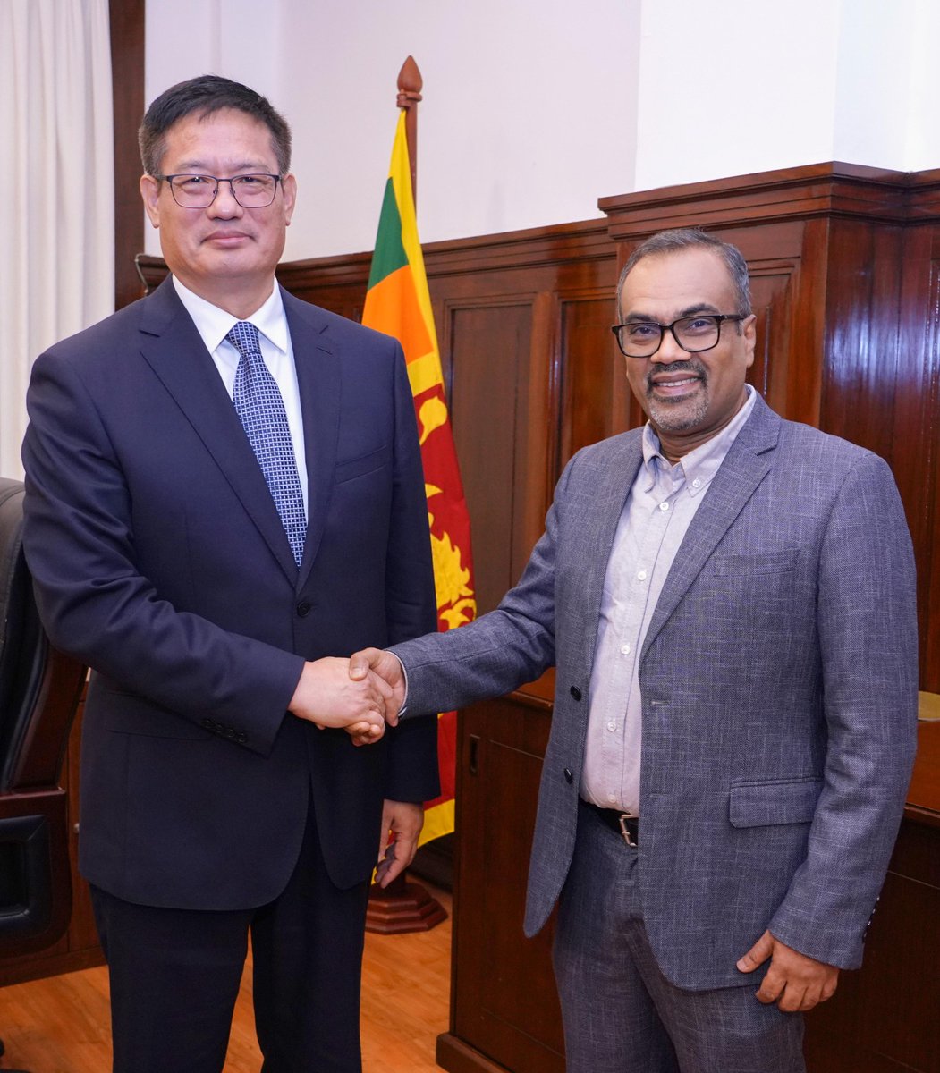ChinaEmbSL's tweet photo. On 14 October, H.E. Ambassador Wei Huaxiang paid a call on Hon. Anil Jayantha Fernando, Minister of Labour and Deputy Minister of Finance and Planning of Sri Lanka. They held an in-depth and friendly discussion on various China Aid projects in Sri Lanka, efforts to advance the signing of the China–Sri Lanka Free Trade Agreement, investment cooperation, and other related matters. Counsellor Tang Yandi, in charge of economic and commercial affairs, also attended the meeting.