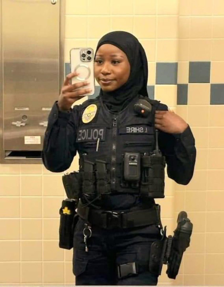 AmyMek's tweet photo. 🚨UTAH’S FIRST SOMALI MUSLIM HIJABI FEMALE COP IN SALT LAKE CITY

We keep warning Utah about the quiet Somalification of their red state, the machine is continuing to roll. 

Isha Hussein Shire made history as the first Somali girl to join the Salt Lake City / Sandy Police Department in Utah.

A proud hijabi officer now patrolling the streets of Mormon country celebrated as an “inspiration” by Somali and Left-wing media.

This is exactly what we’ve been exposing for the past several years:

The same Somali Bantu community of ~10,000 openly bragging about “taking over slowly,” pocketing $5.7 million+ in federal grants, steering kids toward the full Islamic “deen,” and building parallel networks is now placing its members in positions of authority.

And Utah is embracing it.

Political Leaders and Police host Iftars.

The LDS Church donates $25,000 of your tithing dollars to build every new or expanding mosque in the state, including Utah’s largest Islamic center.

Christian compassion, taxpayer money, and Mormon generosity are being used to fund the very infrastructure accelerating this transformation.

First the refugee pipeline.
Then the youth programs and mosques.
Then the political candidates like Liban Mohamed who will not stop until he eventually gets elected.
Now the police department.

Utah the reddest, most family-oriented state in America, is being remade in real time.

This is demographic conquest with a smile and a uniform. Where does it end exactly?

Utahns especially Latter-day Saints demand answers.

Audit the grants. Audit the tithing.
Pause the resettlement.

Protect your culture, your communities, and your children’s future.

The “Mormon State” must not become the “Little Somalia of the Rockies.”

PAY ATTENTION, UTAH.
