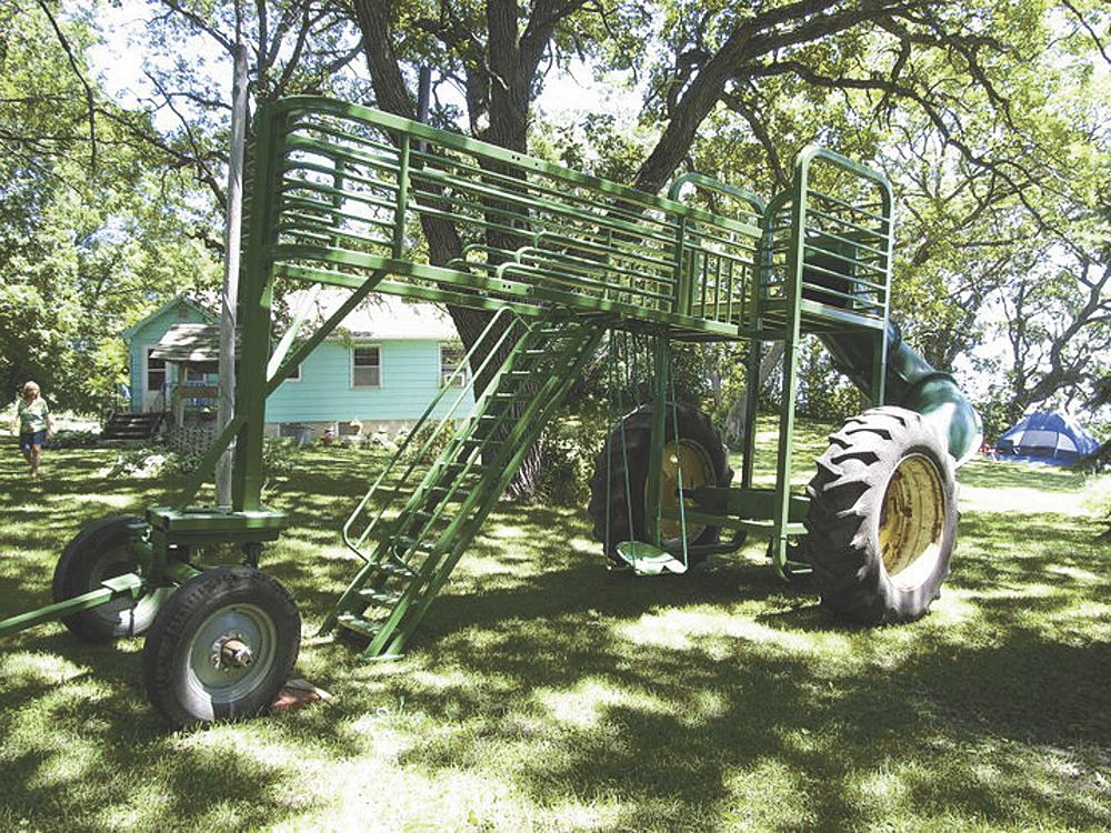 FarmShow's tweet photo. Grown men who would never go down a water slide might be tempted to try out David Seifert’s slide. The giant slide rolls on Deere tires and is shaped like a tractor with a big tube slide at one end. https://t.co/0KMXPcQoIc https://t.co/47Ji04HAsb