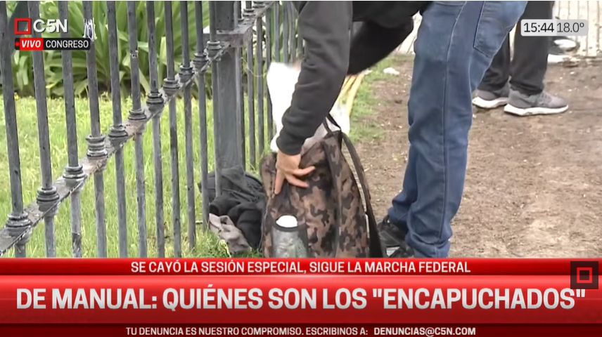 El_vengaK's tweet photo. C5N filma a un "encapuchado" guardando su uniforme.
El tipo se da cuenta y reacciona a las trompadas. 
Desde la marcha aquella del policia que se le cayó el arma al pasto que no veiamos tanta impunidad https://t.co/RYCPXmFccl