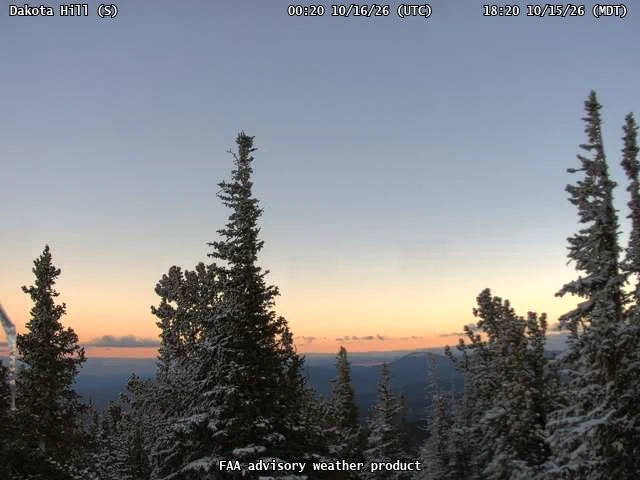 Snow covered evergreen trees looking south from the Dakota Hill FAA camera