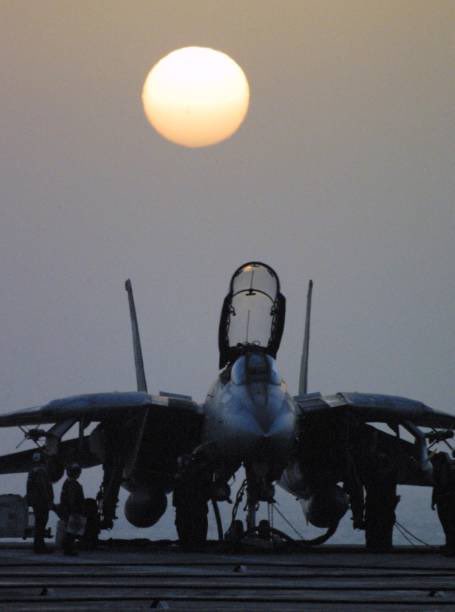 25YearsAgoLive's tweet photo. Sunrise in the Indian Ocean: American fighter jets rally aboard the USS Enterprise for another day of strikes on Afghanistan. https://t.co/idx9bMtsJB