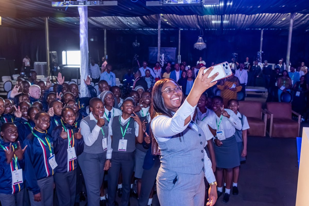 MICTNamibia's tweet photo. NATIONAL YOUTH DAY | The National Youth Day of the 9th National ICT Summit opened with a captivating performance from the Gabrial Taapopi Senior Secondary School Choir on Thursday, 15 October 2026, at the Ongwediva Trade Fair Centre. The summit brings together local and international ICT industry players from across industry, governance, and academia to discuss trends, developments, and challenges facing the ICT industry.

Addressing the youth who showed up in numbers for the National Youth Day, Hon. Emma Theofelus Minister of Information and Communication Technology, highlighted the importance of ethical behaviour on social media, imploring young people to remain conscious of their digital footprint and exercise caution in what they share online so as not to be targeted in the cyberspace. She noted that while cybersecurity is important, the first line of defence remains personal censorship, and encouraged the youth to develop practical habits around password safety, recognising online scams and patterns, and practising ethical hacking. She further noted that the youth present sit on great potential to become digital literacy ambassadors, capable of educating others on how to be safer online.

Delivering the welcoming  remarks, Deputy Minister of ICT, Hon. Wenzel Kavaka, called on the youth exhibitors to use the opportunity to learn, collaborate, ask questions, and develop solutions that respond to Namibian needs. He further called on industry partners and established institutions to mentor, support, and invest in the promising young innovators present.

Speaking on behalf of the Deputy Minister of the Ministry of Education, Innovation, Youth, Sports, Arts and Culture, Deputy Director of Training and Employment, Mr. Lysias Haiduwa, noted that ensuring every learner has a fair opportunity to participate in the digital future is a shared responsibility. He emphasised that young people should simultaneously be equipped with practical digital skills that respond to the growing needs of the ICT industry, opening pathways to employment in the ICT sector.

Young innovators were challenged to develop a media monitoring and analysis tool, a solution aimed at helping government track, analyse, and understand public conversations online. A total of 25 group applications were received, and after a rigorous selection process, only five groups were shortlisted. Meanwhile, 28 applications from young ICT innovators wishing to exhibit their innovations at the ICT Summit 2026 were received, with 10 exhibitors selected to showcase their projects at the summit. 

#9thICTSUMMIT2026