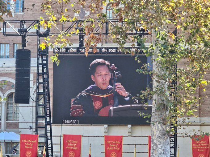 InsideUSC's tweet photo. USC president Beong-Soo Kim plays the cello at his Investiture ceremony at Alumni Park https://t.co/GD2vV51fze