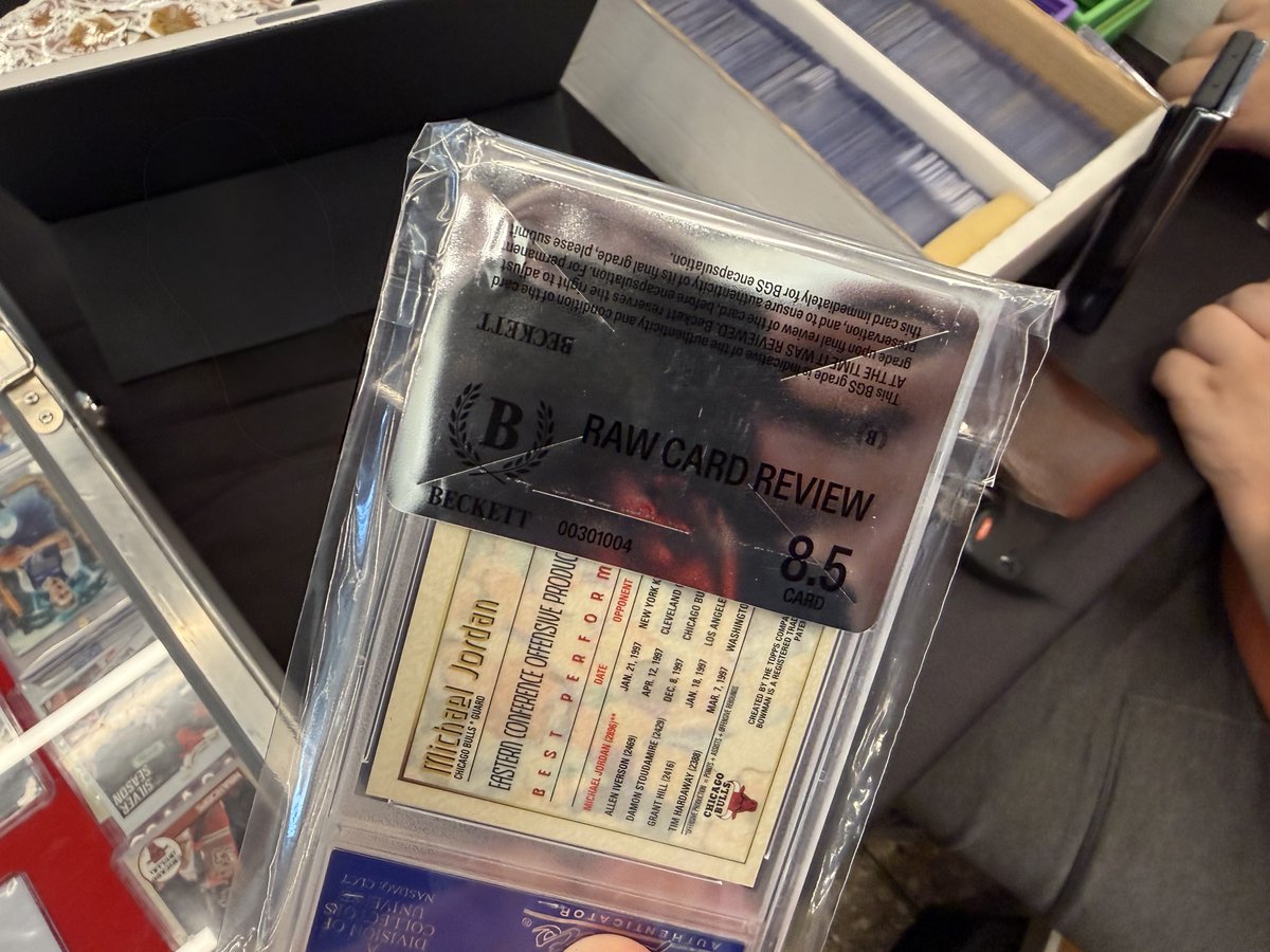 andyjonesesquir's tweet photo. Let’s talk about one of the biggest challenges with card grading in the hobby.

Consistency.

Someone stopped by our booth at a recent show with a Bowman’s Best Michael Jordan Refractor.

It’s currently in a PSA 10 holder.

The collector was considering crossing the card over to Beckett, so they had Beckett perform a Raw Card Review at the show.

Beckett’s opinion?

8.5.

Think about that.

One major grading company looked at this card and determined it was Gem Mint 10.

Another major grading company looked at the same card and determined it was an 8.5.

That’s a point and a half difference on the exact same card.

And in this hobby, that difference matters.

Grades can have a significant impact on value. Collectors buy based on them. Dealers price based on them. Investors make decisions based on them.

Yet ultimately, grading still involves a person or grading system making a judgment about a card.

With millions of cards being graded, consistency becomes incredibly important.

Collectors aren’t just paying grading companies to put cards into plastic holders.

They’re paying for the opinion represented by the number on the label.

When one respected grading company says 10 and another says 8.5, it raises an important question for the entire hobby:

How much confidence should we put in the number?

Because when that number can change the value of a card substantially, consistency isn’t a small issue.

It’s fundamental to the entire grading business.