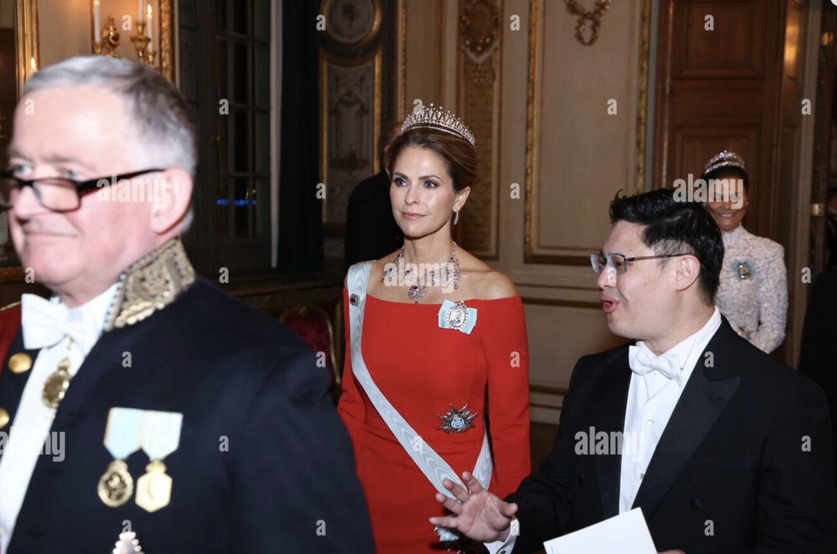 RNN_RoyalNews's tweet photo. Princess Madeleine of Sweden wore her Modern Fringe Tiara and also the Edward VII Ruby Tiara as a necklace. However, the necklace did have a bit of a disappearing act. She wore it for the greeting and into the dining room, as shown in the photo of her sitting with it on, viewed from behind. But when the camera moves around to the other side of the table, it's gone. It's an older piece, so I wonder if the clasp broke or something and they had to retire it for the evening.
