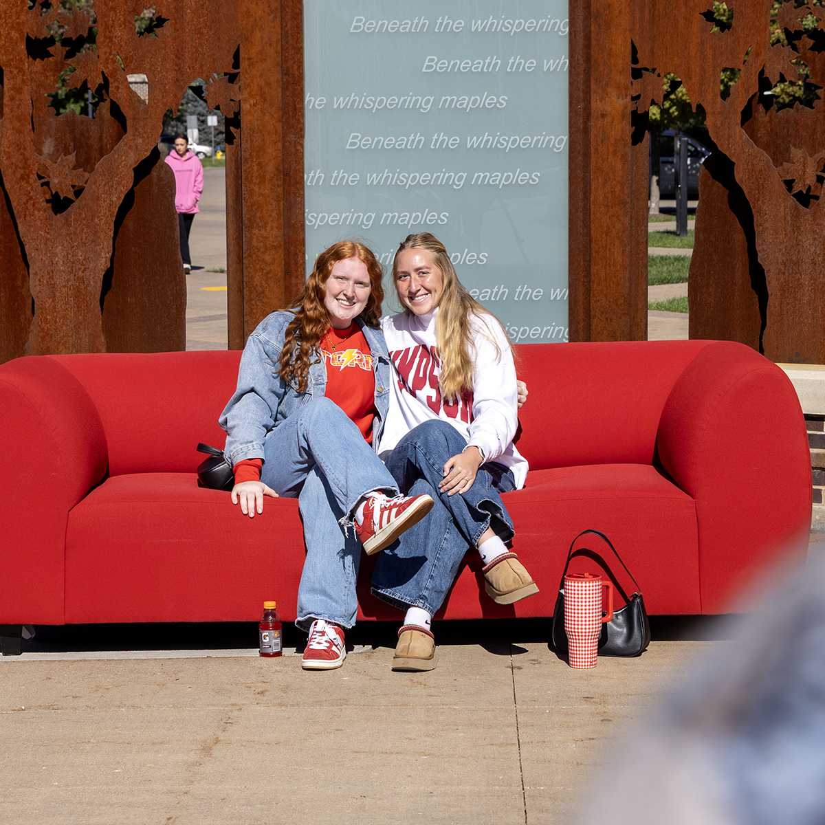 SimpsonCollege's tweet photo. A Homecoming tradition worth sitting down for! From friends to alumni, the red couch brings Storms together year after year. ❤️💛 https://t.co/8m6rRi7OEu