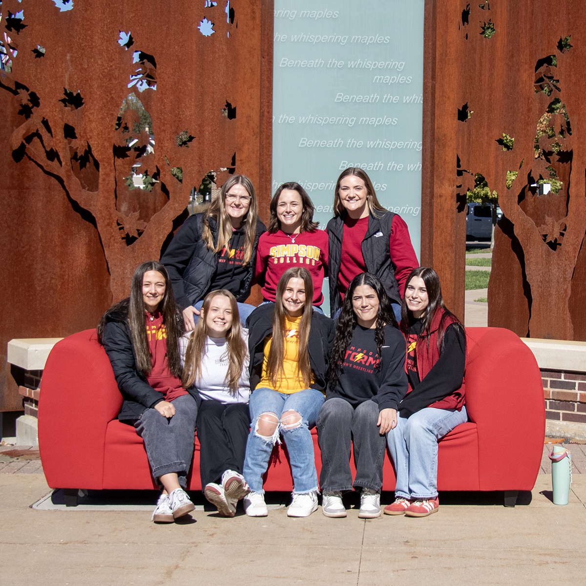 SimpsonCollege's tweet photo. A Homecoming tradition worth sitting down for! From friends to alumni, the red couch brings Storms together year after year. ❤️💛 https://t.co/8m6rRi7OEu