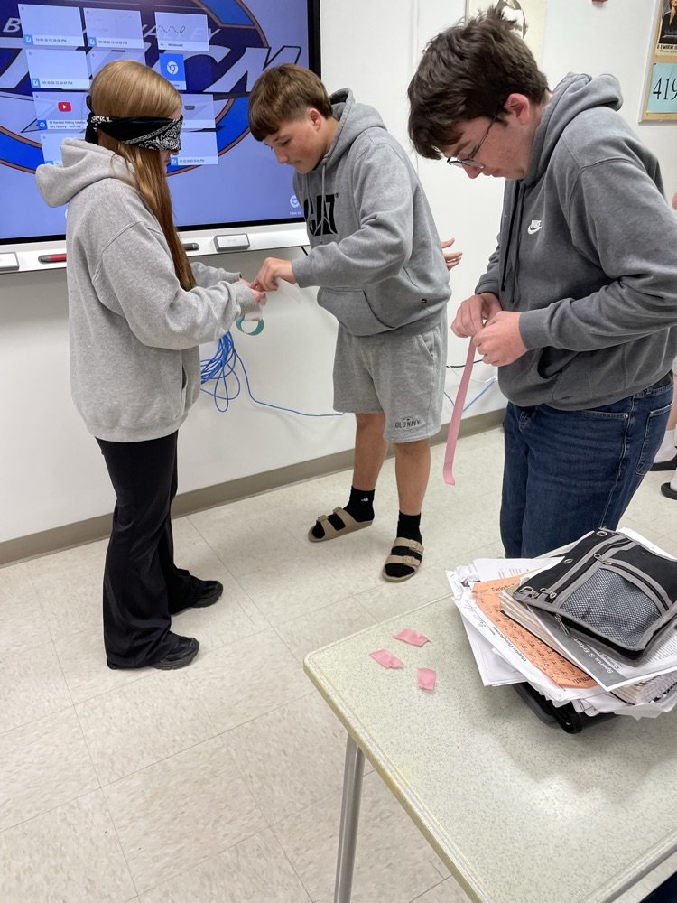 BVHS340's tweet photo. Students in Driver's Ed. working on overcoming obstacles to build the longest paper chain with Mrs. Stoller. https://t.co/p8CnD3jyUR