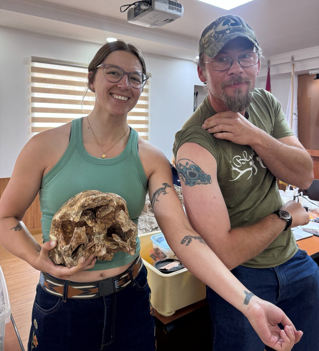 DoubleBeam's tweet photo. If I had a nickel for every paleontologist with a pachycephalosaur tattoo posing with a pachycephalosaur fossil, I’d have two nickels. Which isn't a lot, but it's weird that it happened twice.

Here's Sally Hurst &amp; I with a HUGE specimen of Prenocephale we're working on. https://t.co/dkPmEoyNq6