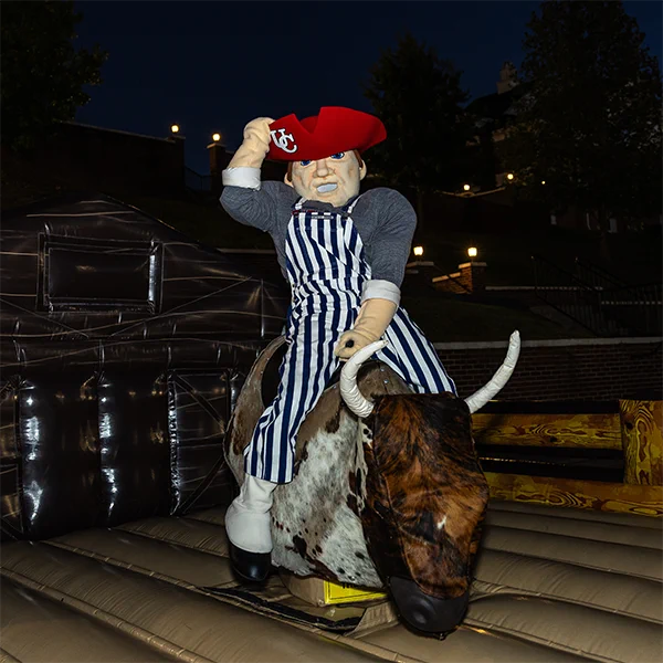University of the Cumberlands Pete the Patriot rides a mechanical bull at the Hoco Hoedown on the Wellness Lawn.