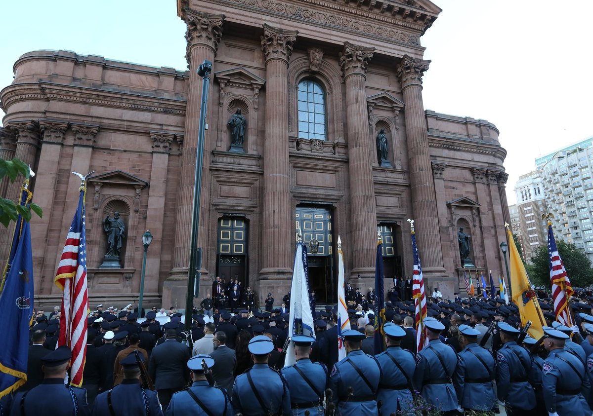 FD4D's tweet photo. October 20. 2026 (Philadelphia, PA) Today a funeral service was held at the Cathedral Basilica of Saints Peter and Paul for Slain Philadelphia Police Officer Shane Seiber, 40. He is remembered by his wife, Lisa, and their two children, Finn and Emily. Seiber, the 10-year veteran officer, was shot and killed in West Philadelphia after responding to a report of a man with a gun, police said. His wife is pictured holding the folded American Flag. @PhillyFireNews @PhillyPolice @PhillyInquirer @NBCPhiladelphia @ABCPhiladelphia @CBSPhiladelphia @AP @NYCEMSwatch