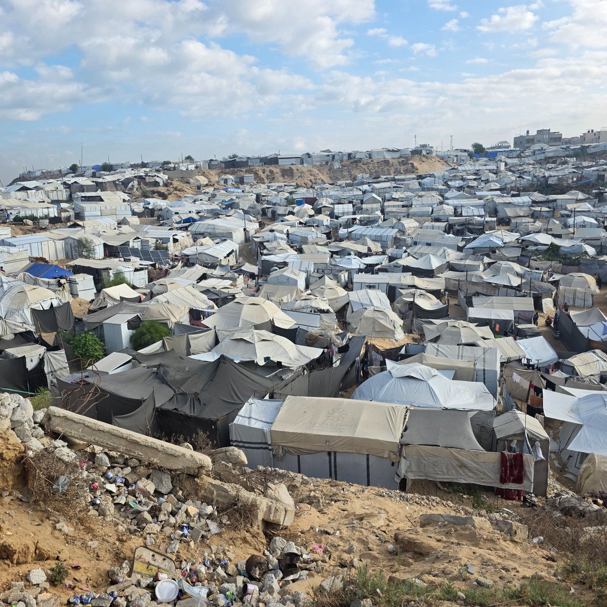 ochaopt's tweet photo. Today in Khan Younis #Gaza, we visited low-lying displacement sites at risk of being flooded when heavy rains begin. We're helping some relocate voluntarily and securing proper drainage for those staying. But to respond at scale, more funding and fewer restrictions are critical. https://t.co/mUq3cKH77Z