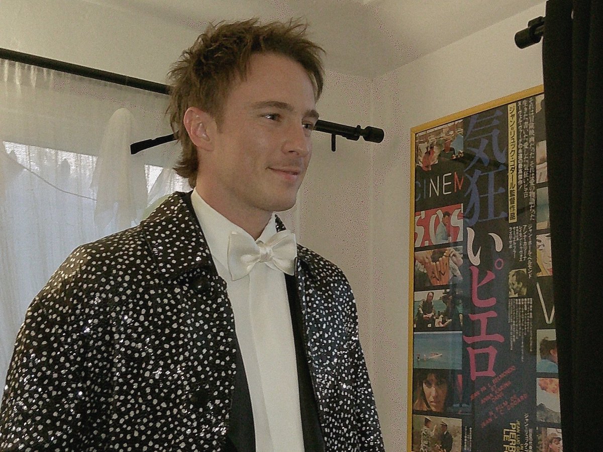 A Pierrot le Fou movie poster hanging in the background… Drew Starkey ...