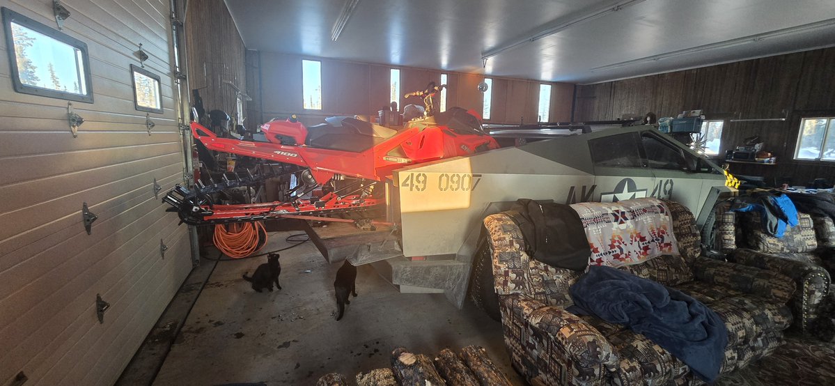 markhkinak's tweet photo. Thats a 2022 boondocker DS 4300. Track is 163"  i bought a tri fold ramp from bass pro then modified it.  To keep the carbides on the skiis from messing up the bed I cut a sheet of plywood just past the front bed tie downs (foundation series has 8 tie downs)  I notched it for that tie down but probably wouldn't do that as I used the front side mounted for the nose of the sled. I cut the plywood so when I off load i can flop the back 6' into the bed and close it all up so nothing gets snowed on or disappears.  Rides fine. Track pretty much sits on the tailgate. With reverse its easy to load and unload. It does hang over by about 3.5 ish feet :-)