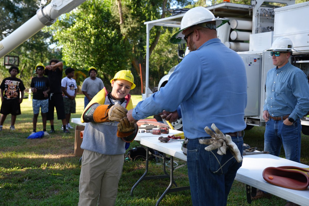 WRECCoop's tweet photo. WREC's Michael Gulvin, Travis Brown and Kameron Mathis enjoyed spending time with students at The Christian Edge's Touch-A-Truck event, showcasing the equipment our lineworkers use every day, demonstrating PPE, and sharing how we work safely to serve our communities. #WRECcoop https://t.co/xhovQderqs