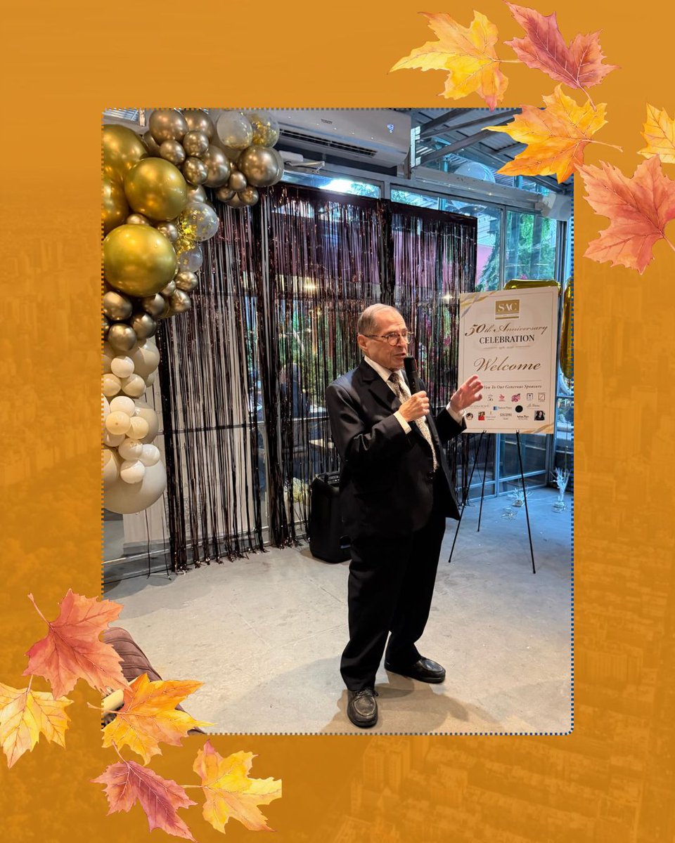 A framed photo shows an older man in a suit speaking into a microphone at a decorated anniversary event. Gold and white balloons, a shimmering curtain, and a welcome sign are behind him. The photo is surrounded by an orange autumn-themed border with decorative leaves. Text appears on the sign.