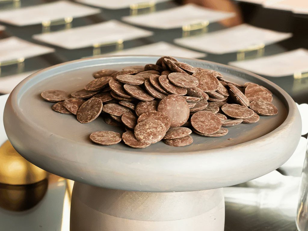 johncumbers's tweet photo. Chocolate is becoming a biomanufacturing story.
Galy just launched WunderHaus, a chocolate made with cocoa grown from cells in tanks in Massachusetts.

Galy is a Boston biotech founded in 2019 by Luciano Bueno and Paula Elbl. It grows plant cells in bioreactors instead of soil.

The investor list is serious. Galy raised a $33 million Series B in 2024, led by Breakthrough Energy Ventures, the fund Bill Gates founded. H&M Group and Inditex joined that round. Earlier backers include Sam Altman's Hydrazine Capital, Material Impact and John Doerr's family office, Eighty Eighty Group.

Luciano first came to SynBioBeta in 2021 and spoke with us in 2023. Back then Galy was known for lab-grown cotton. This year it won Silver at the Edison Awards for its cocoa and cotton platform.

Chocolate companies hit by the climate crisis asked whether the same platform could make cocoa. Galy went from lab to commercial scale in under a year.

How it works:
- Start with a small piece of cocoa bean
- Multiply the cells in brewery-style tanks
- Ferment, roast and grind the harvest into cocoa powder
- Produce in Essex, MA, in repurposed existing infrastructure

Where it stands:
- Cocoa powder self-affirmed GRAS, with FDA notified
- WunderHaus is built for professional kitchens: couverture and baking chocolate
- First customer is Troquet on South in Boston, which stocked its whole kitchen with it
- UAE launch targeted for 2027, backed by a purchase order from a Dubai chocolatier
- Blended with conventional cocoa, with partnerships in the works with growers in Africa and Latin America

Cocoa prices hit an all-time high in 2024. Supply is fragile and weather dependent.

The part I care about most is the platform. A system built for cotton now makes cocoa. Biomanufacturing should work like this: one platform, many crops, production that doesn't depend on weather or farmland.

Congrats to Luciano and the Galy team.