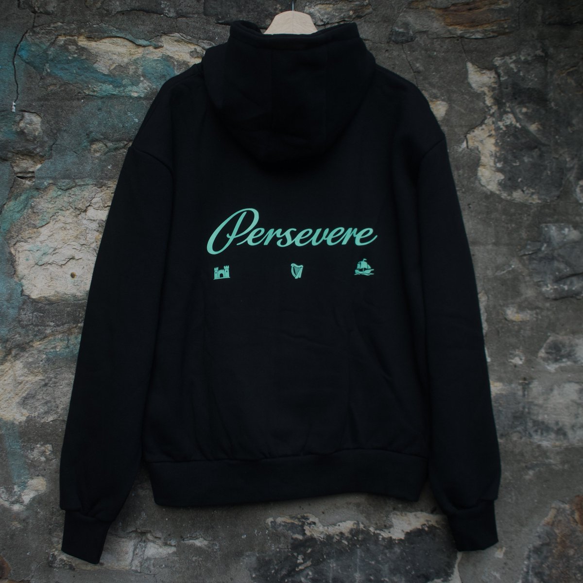 PersevereOG's tweet photo. Introducing the Persevere Originals Script Hoodie! 💚

A heavyweight, deep-black hoodie featuring our distinctive harp design on the front with Persevere script and small symbols across the back 🏰🪉⛵️

Available now in sizes Small to XXL

https://t.co/ImdhouRVAT https://t.co/4vP4PbvOfA