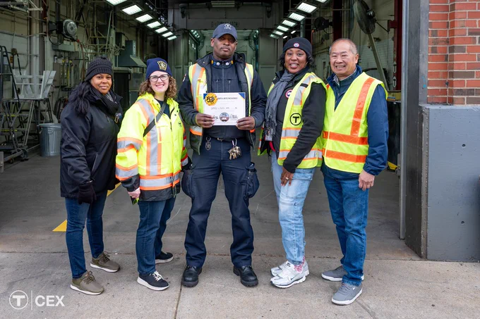 The winner of the bus driving competition at the Bus Roadeo alongside the General Manager, heads of training, and operations.